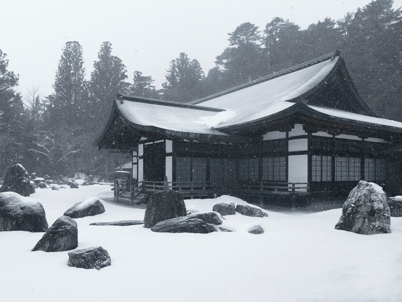 snow-covered old temple during winter season in japan