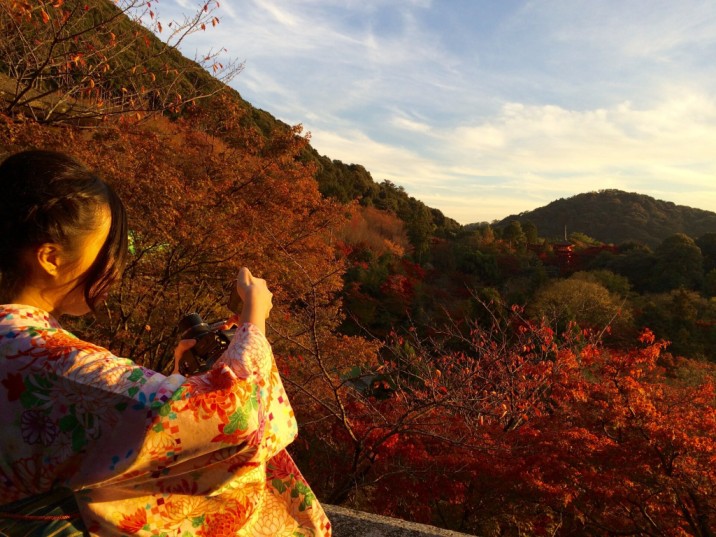 senior japanese student celebrating graduation on mountain