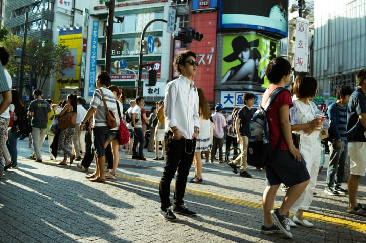 tourists in crowded place in japan using basic japanese