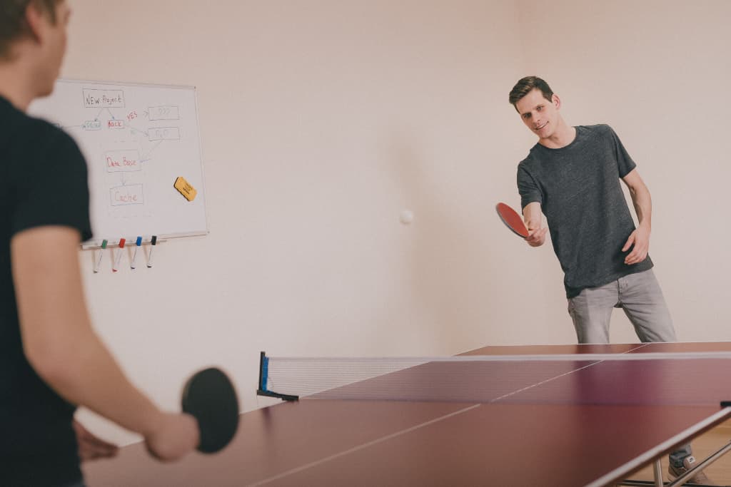 foreigners playing pingpong in social apartment in tokyo