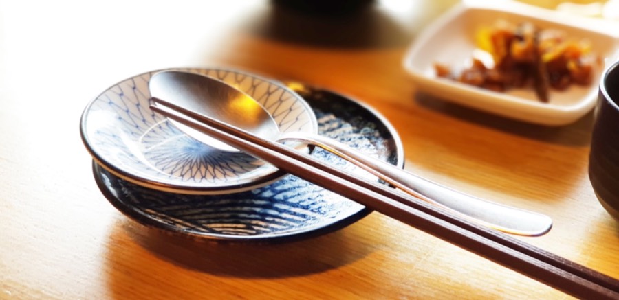 a picture of a set of chopsticks on a small plate japanese superstition