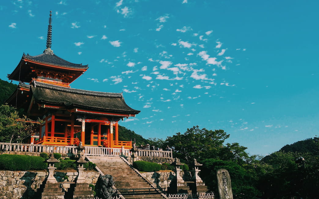 Red temple in Japan surrounded by greenery