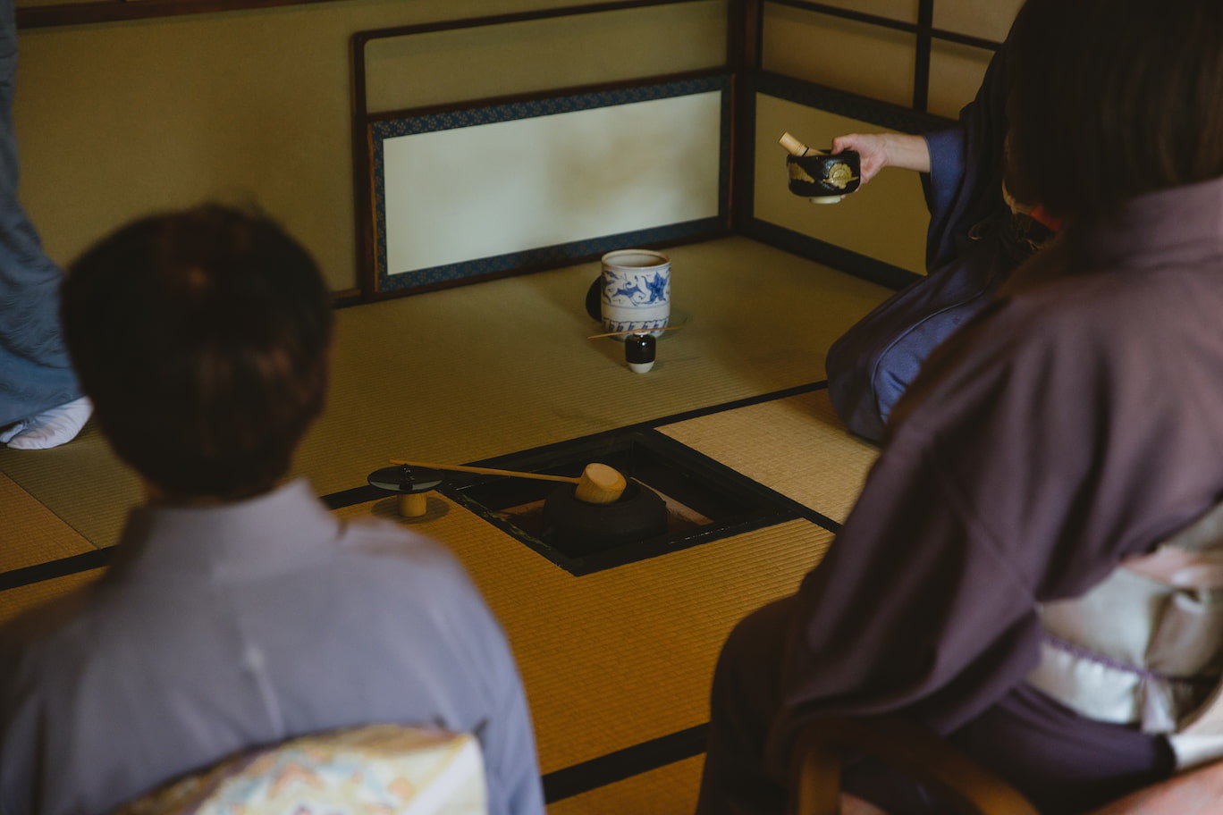 Women kneeling and participating in a tea ceremony in Japan