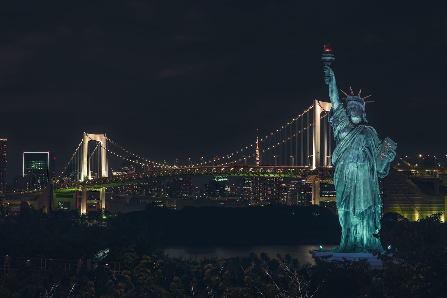 See the miniature Statue of Liberty lit up at night as one of the things to do in Odaiba