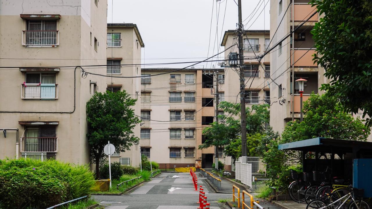 Street view of Tokyo housing and blocks of apartments that are around 3-4 storeys each