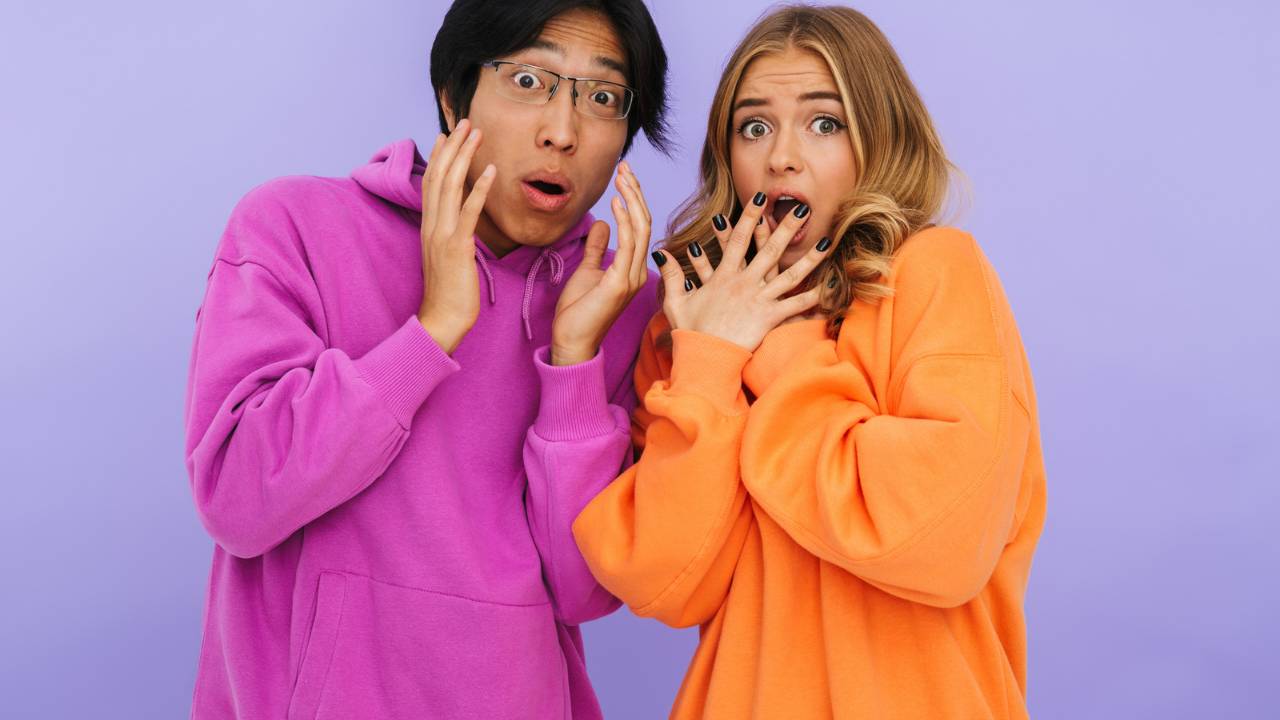 Two friends, one male and female, looking shocked