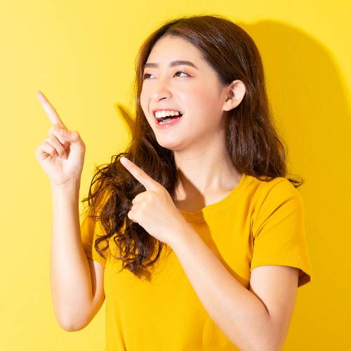 woman in yellow t-shirt pointing