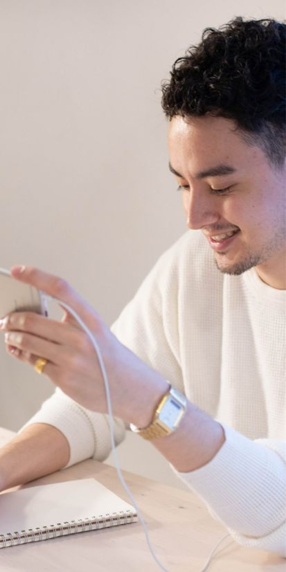 Male student learning Japanese online using smartphone