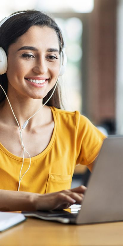 Woman using laptop to take online Japanese lessons