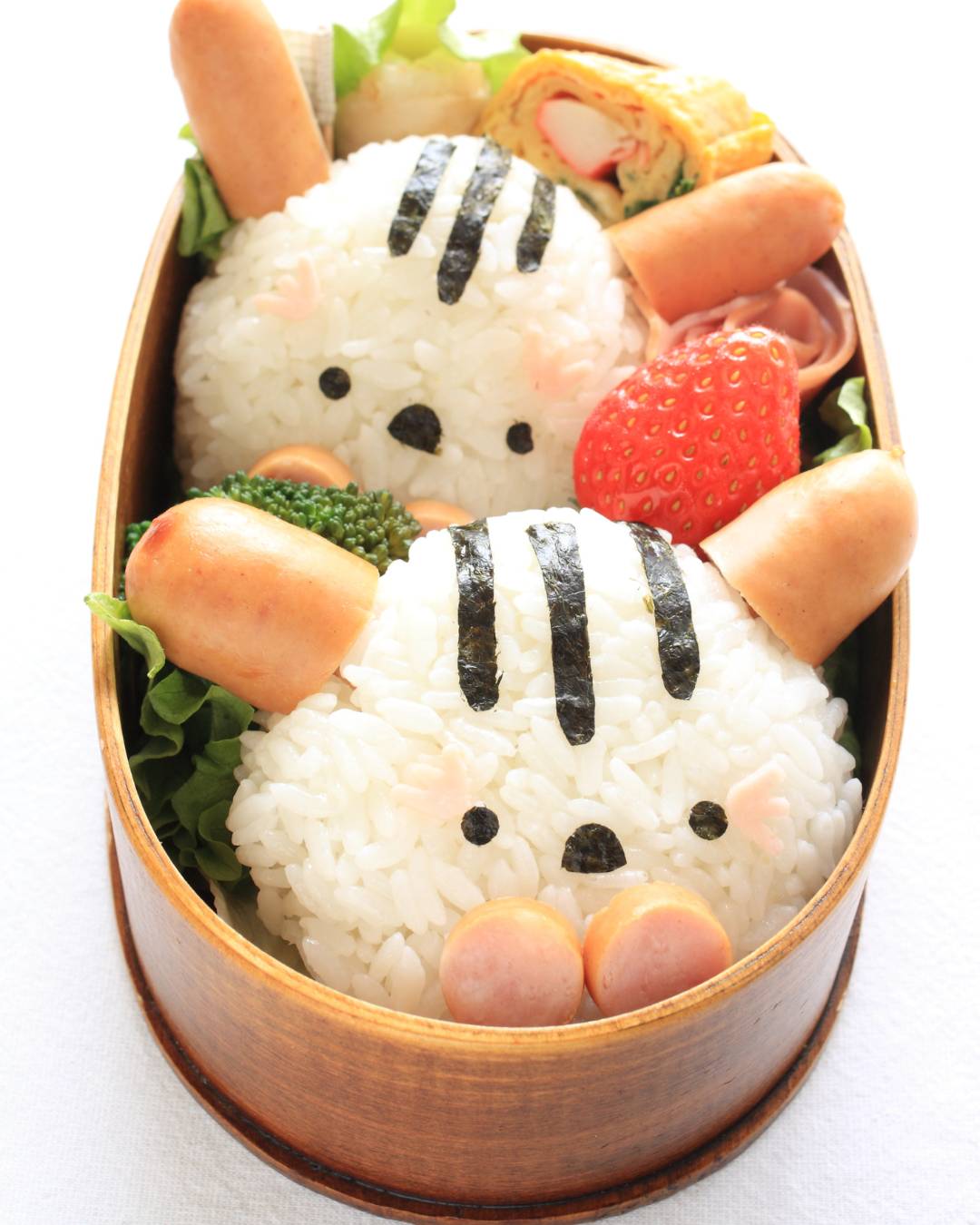 Kyara-ben with rabbit shaped onigiri - sausages for ears, and seaweed used to create face