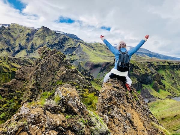 A hiker victorious on their Tokyo mountain climb