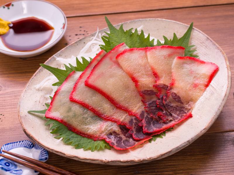 kujira on a plate (white meat in the center, bright pink on the edges, a weird japanese food based on looks but tastes like meat)