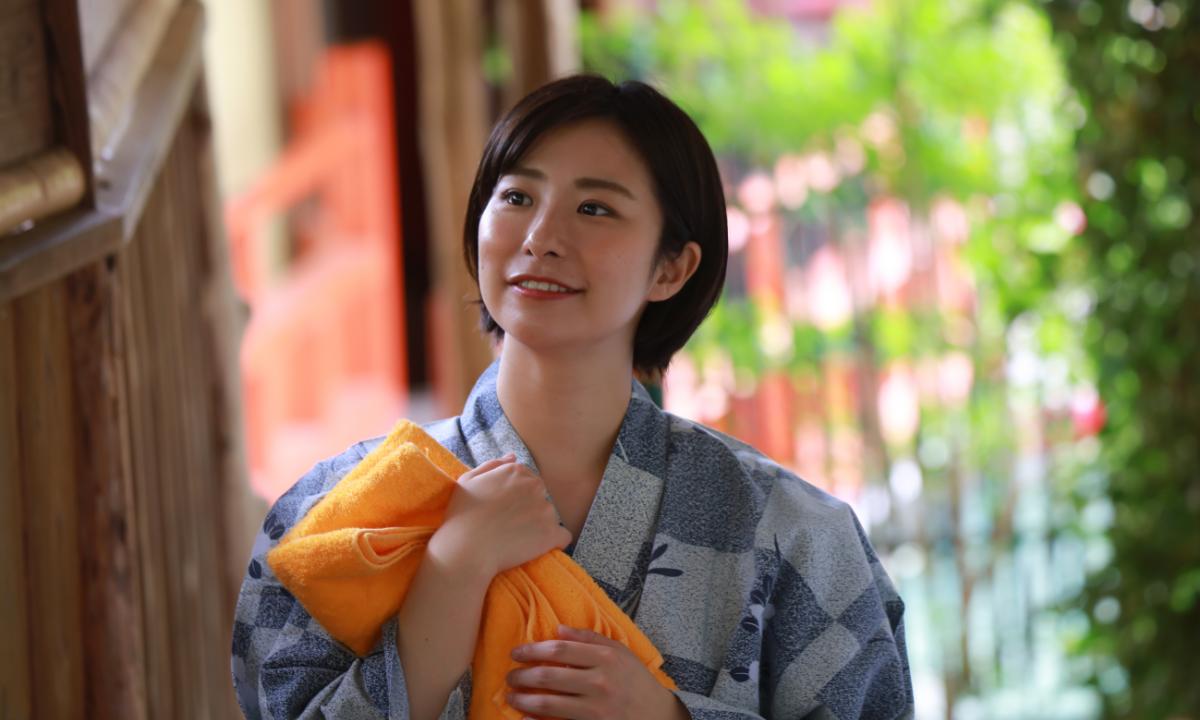 Japanese staff holding towels at Tokyo ryokan