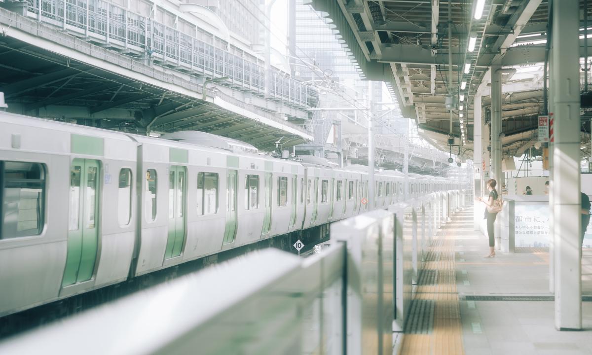 Image of silver and green train at a train station in Tokyo
