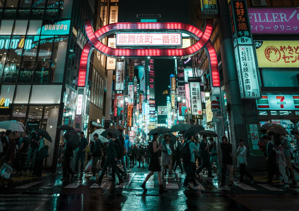 A street in Shinjuku illuminated by neon lights at night