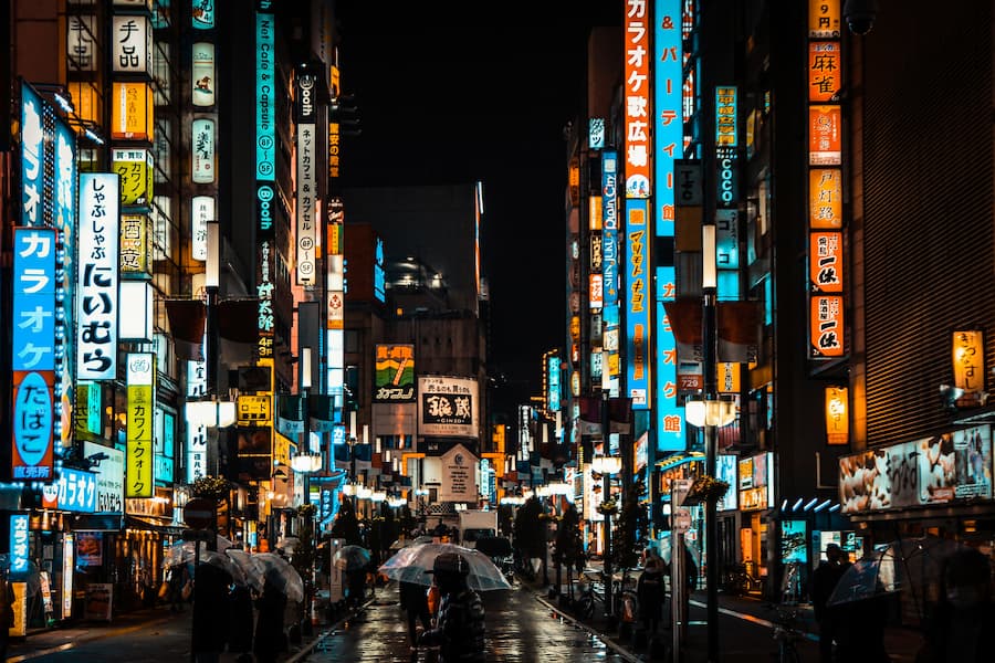 A street in Shinjuku illuminated by neon lights