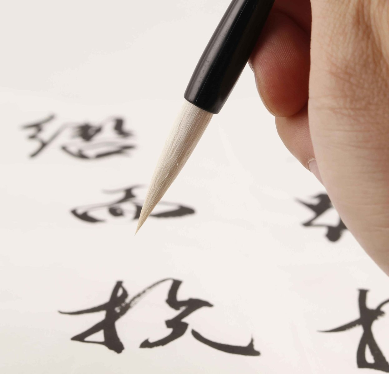 a person writing kanji for jlpt practice