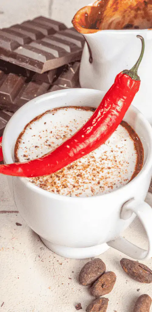 A picture of the best mexican food in tokyo, a spicy hot chocolate in a white cup with chili on top of it.