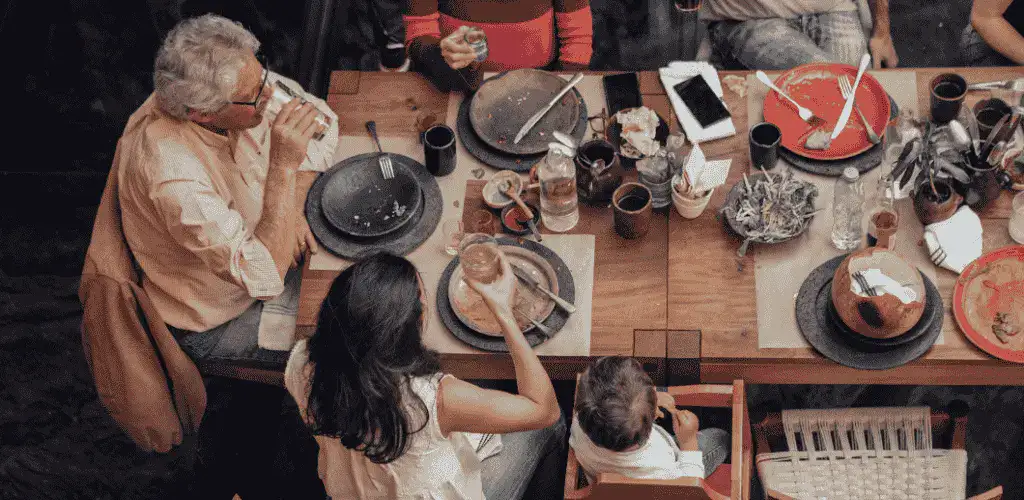 A top view image of a family eating at a restaurant of the best Mexican food in Tokyo while drinking, eating, and chatting.