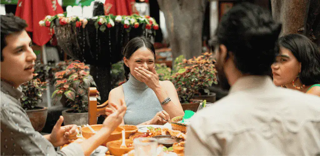 A group of friends eating the best Mexican food in Tokyo focusing on a woman who is laughing.