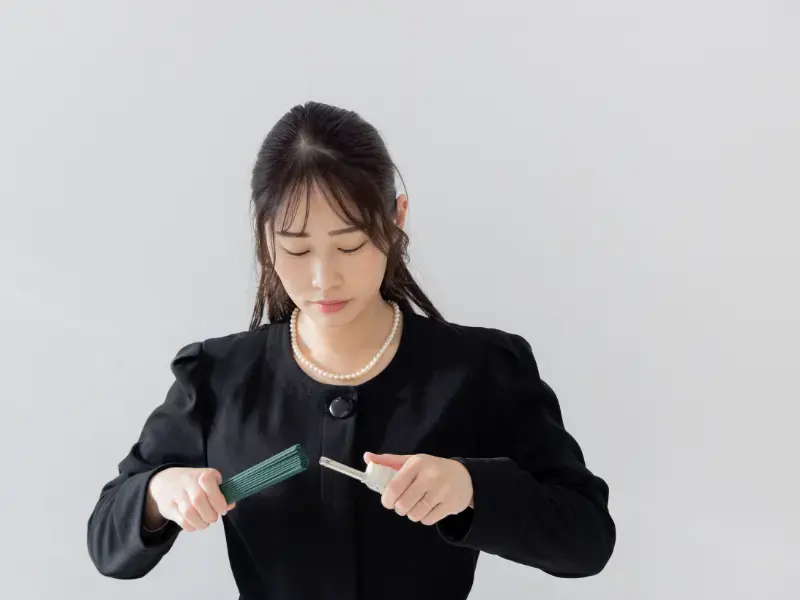 incense being lit at a Japanese Funeral