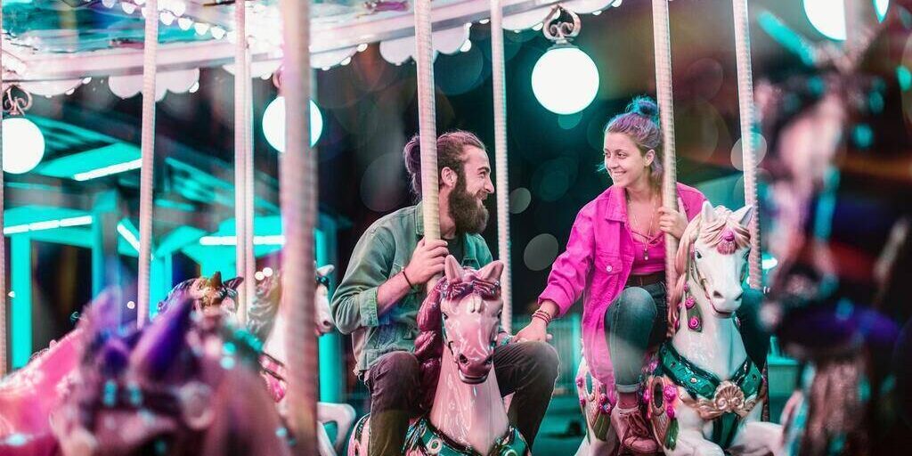 couple in carousel ride amusement park date in tokyo