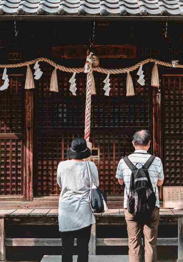 people praying in shrine in tokyo